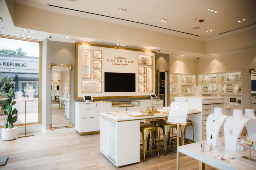 A showroom with various Kendra Scott products on different display mannequins