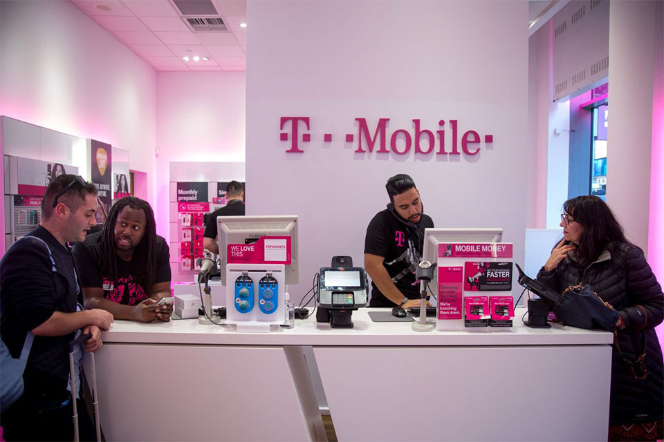 Several people trying phones in the T Mobile showroom