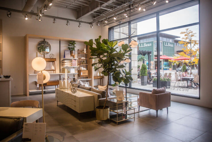 The West Elm showroom with arranged furniture and a large glass window at the back of the room